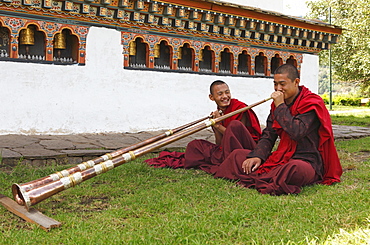 Monks playing tibetan horns, Chimi Temple, Punakha District, Bhutan, Asia