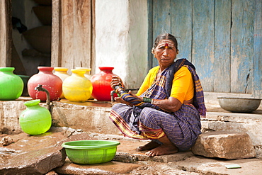 Elderly woman washing her hands, Aihole, Karnataka, India, Asia