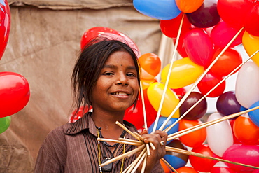 Portrait of a young girl with colorful balloons, Pushkar, Rajasthan, India, Asia