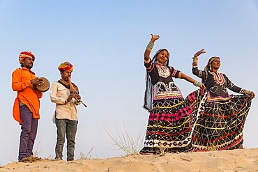 Two women dancing, musicians, Pushkar, Rajasthan, India, Asia