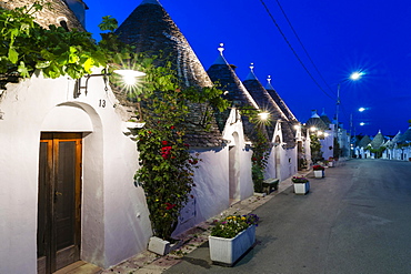 Trulli, traditional round houses, trullo settlement, at dusk, blue hour, Rione Monti district of Alberobello, Valle d'Itria, Trulli Valley, Apulia, Italy, Europe