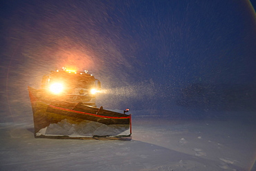 Snowplow in the arctic blizzard during the polar night, Longyearbyen, Svalbard, Norway, Europe