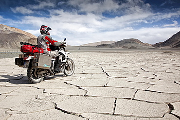 Motorcyclist travelling on the Pamir Highway, M41, Province of Gorno-Badakhshan, Tajikistan, Asia