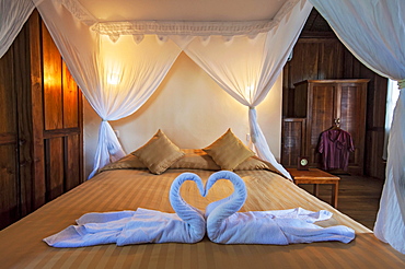 Bed in Palm Bungalow, Wakatobi Dive Resort, Sulawesi, Indonesia, Asia