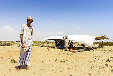 Rashaida man standing in front of his tent in the desert around Massaua, Eritrea, Africa