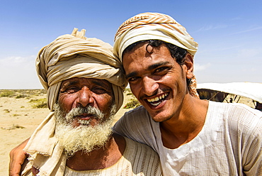 Rashaida father and son standing in front of their tent in the desert around Massaua, Eritrea, Africa