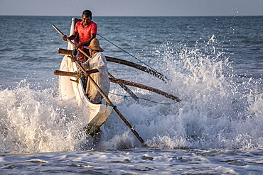 Fishermen breaking the waves at Kahandamodara beach, Sri Lanka, Asia