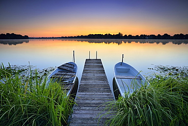 Dawn at the lake Grosser Mullroser See, wooden footbridge with rowboats, Mullrose, nature park Schlaubetal, Brandenburg, Germany, Europe