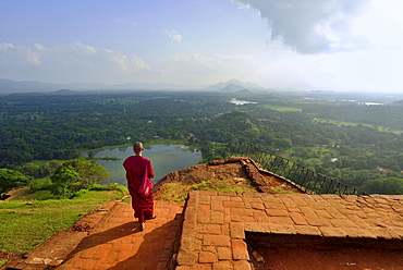 Buddhist nun enjoying the view from the ruins of the fortress on the Lion Rock, Sigiriya, UNESCO World Heritage Site, Sigiriya, Central Province, Sri Lanka, Asia