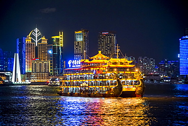 Illuminated dragon boat, pleasure boat on Huangpo, from The Bund, Hyatt at The Bund at the back, at night, Shanghai, China, Asia