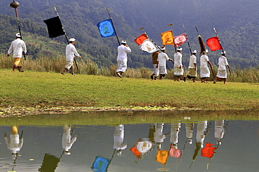 Procession, flags, reflections in the water, Lake Bratan, Bali, Indonesia, Asia