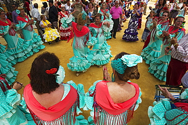 Women wearing gypsy dresses perform traditional Andalusian dances at the Feria del Caballo, Jerez de la Frontera, Cadiz province, Andalusia, Spain, Europe