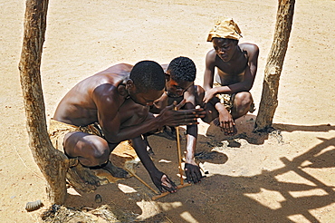 Three local men making fire, Damara Living Museum, near Twyfelfontein, Namibia, Africa