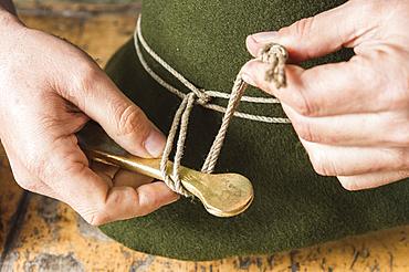 Tightening the shaping cord around a wool felt hat, using iron tool, hatmaker workshop, Bad Aussee, Styria, Austria, Europe