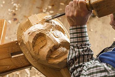 Carving the face of a wooden mask into wooden block using wood carving tools, wooden mask carver, Bad Aussee, Styria, Austria, Europe