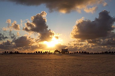 Silhouette of stilt houses on the beach of St. Peter-Ording at sunset, Sankt Peter-Ording, North Friesland district, Schleswig-Holstein, Germany, Europe