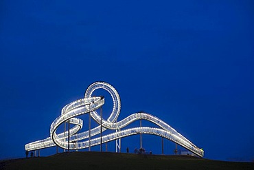 Large-scale sculpture "Tiger & Turtle" - Magic Mountain designed by Heike Mutter and Ulrich Genth, at dusk, Duisburg, Ruhr Area, North Rhine-Westphalia, Germany, Europe