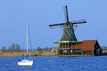 Boat and Windmill in Zaanse Schans open-air museum, Zaanstad, North Holland, Holland, Netherlands, Europe