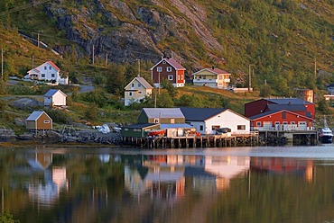 The houses of Reine and their reflection in the calm Norwegian Sea, island of Moskenesoy, Moskenesoy, Lofoten archipelago, Nordland, Norway, Europe