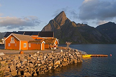 Rorbuer huts, rorbu, of the tiny village Sakrisoy, Sakrisoy, mountains at back, island of Moskenesoy, Moskenesoy, Lofoten archipelago, Nordland, Norway, Europe