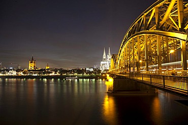 Illuminated Hohenzollern Bridge over the Rhine with the bank of the Rhine, Cologne Cathedral and Gross St. Martin church, Cologne, Rhineland, North Rhine-Westphalia, Germany, Europe, PublicGround