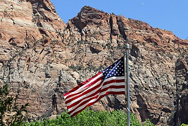 Flag of the United States flying in front of rock formations in the Zion National Park, Utah, USA, North America