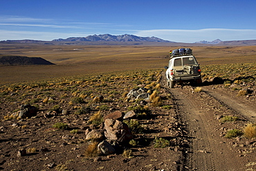 Off-road vehicle on a gravel road, Atacama Desert, Altiplano, southern Bolivia, South America