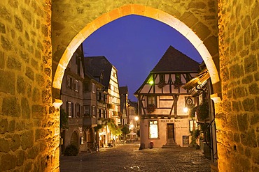 View through Dolder Tower, old town of Riquewihr at dusk, Alsace, France, Europe