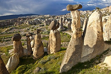 Tufa Fairy Chimneys with basalt blocks placed on top, rock formations at Cavushin, Goreme, UNESCO World Heritage Site, Cappadocia, Anatolia, Turkey