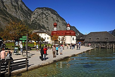 St. Bartholomae chapel on lake Koenigssee with tourists and the landing stage, Upper Bavaria, Bavaria, Germany, Europe