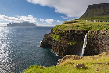 Waterfall into the sea, coast, view towards Mykines Island, Gasadalur, Vagar, Faroe Islands, Denmark, North Atlantic