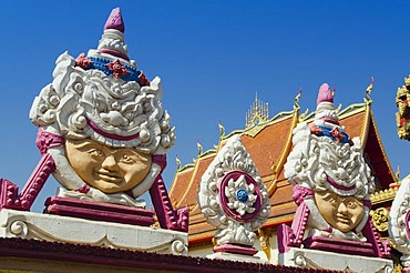 Reliefs of faces in the Buddhist temple at Dongpalan Road, Vientiane, Laos, Indochina, Asia