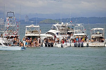 Young people from Panama City celebrating a weekend party on yachts on the island of Isla Taboga, Panama, Central America