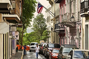 Alley in the historic town centre of San Juan with a Puerto Rican and a U.S. flag, San Juan, Puerto Rico, an unincorporated territory of the United States