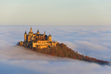 Burg Hohenzollern castle in morning light with autumn forest, morning mist, Schwaebische Alb, Swabian Alb, Baden-Wuerttemberg, Germany, Europe