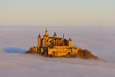 Burg Hohenzollern castle in morning light, early morning fog, Swabian Alb, Baden-Wuerttemberg, Germany, Europe