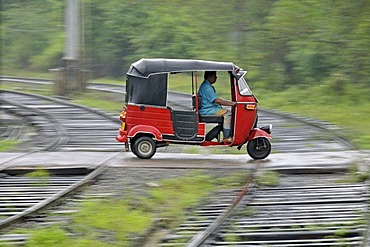 Three-wheeler in heavy rain, railway crossing in Kalawewa, Sri Lanka, Ceylon, South Asia, Asia, PublicGround