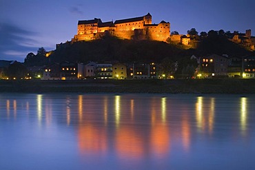 The floodlit Burghausen Castle reflected in the river Salzach at the blue hour, Upper Bavaria, Germany, Europe