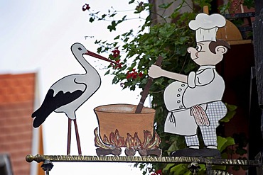 Storch and cook, restaurant sign in Riquewihr, Alsace, Vosges, France, Europe