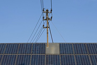 Roof with solar panels and a power pole, consumers produce their own electricity, energy turnaround, PublicGround