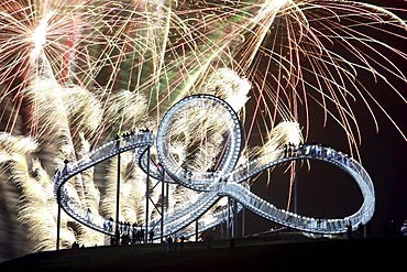 Fireworks display during opening of the walkable landmark sculpture in the shape of a roller coaster, "Tiger & Turtle ? Magic Mountain" by Heike Mutter and Ulrich Genth, Angerpark on Heinrich-Hildebrand-Hoehe, mining waste tip, Duisburg, North Rhine-Westp