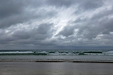 Surfers waiting for waves during stormy weather on the coast of Newquay, Cornwall, England, United Kingdom, Europe