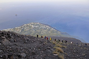 Tourist group hiking to the crater of Mt Stromboli, volcanic island of Stromboli, Aeolian Islands or Lipari Islands, Sicily, Southern Italy, Italy, Europe