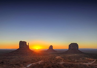 Sunrise, West Mitten Butte, East Mitten Butte and Merrick Butte table mountains and Scenic Drive, Monument Valley, Navajo Tribal Park, Navajo Nation Reservation, Arizona, Utah, United States of America