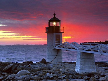 Spectacular sunset behind Marshall Point Lighthouse in Port Clyde, Maine, USA