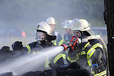 Firefighters extinguishing the fire of two burned-out trucks on the A8 motorway, Stuttgart, Baden-Wuerttemberg, Germany, Europe