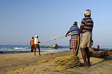 Fishermen fishing the traditional way, in a small village at the coast around Varkala, Kerala, India, Asia