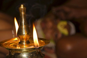 Oil lamp burning during the spiritual ceremony of applying the make-up of the Kathakali dancers, Varkala, Kerala, India, Asia