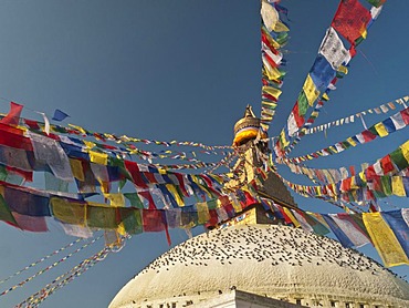 Prayer flags surrounding the top of Boudnath stupa, Boudnath, Kathmandu, Nepal, Asia