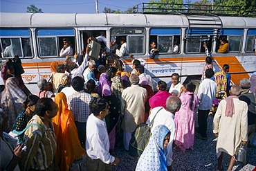 People trying to enter an already overloaded public bus in Bhuj, Gujarat, India, Asia